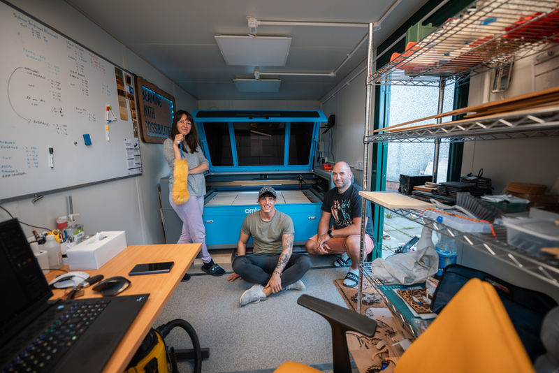 Three colleagues working in the DaVinci workshop with a laser cutter