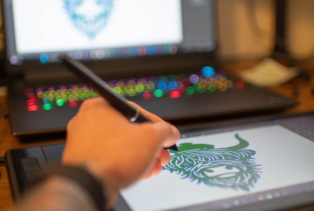 Designer creating digital art on a drawing tablet