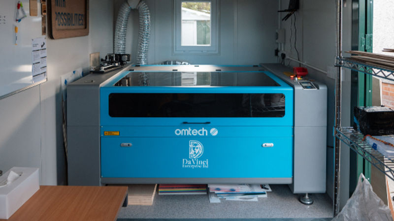 Blue OMTech laser cutter in the DaVinci workshop